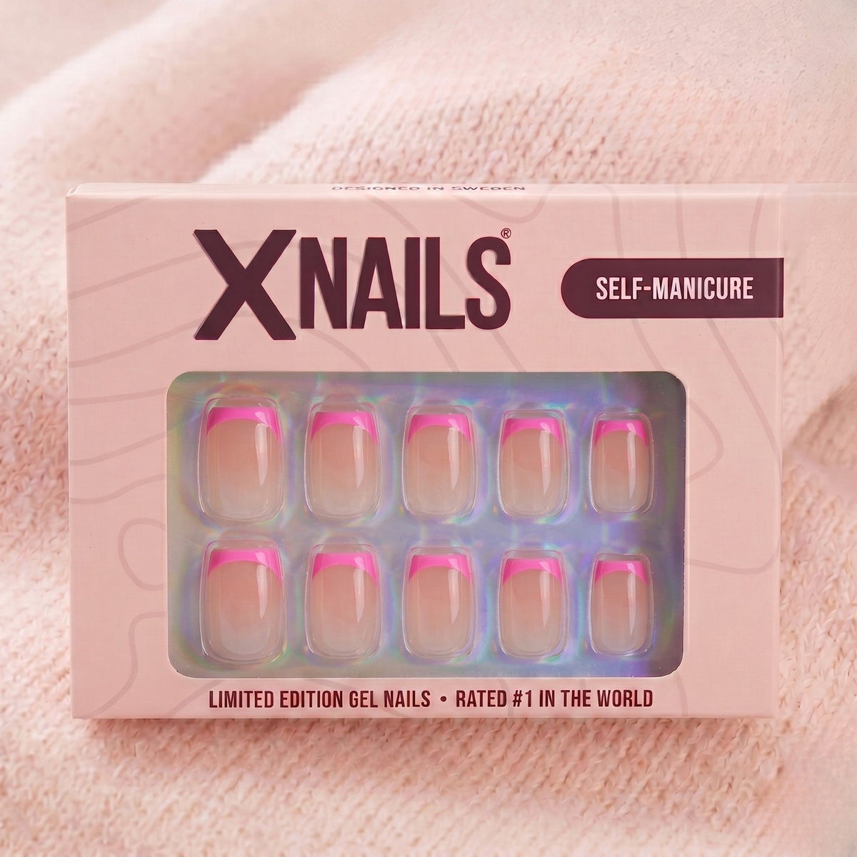 Emballage XNails avec faux ongles french roses courts square sur fond en maille rose
